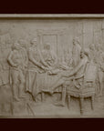 photo of off-white plaster cast relief sculpture of men around a table aka signing the Declaration of Independence, on black background
