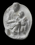 image of a round plaster relief sculpture of the Madonna and Child on a black background