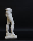 Photo of a decorative sculpture of a man's torso on a black background