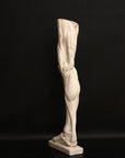 Photo of a sculpture of a leg on a black background