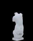 Photo of a sculpture of a ladies torso on a black background