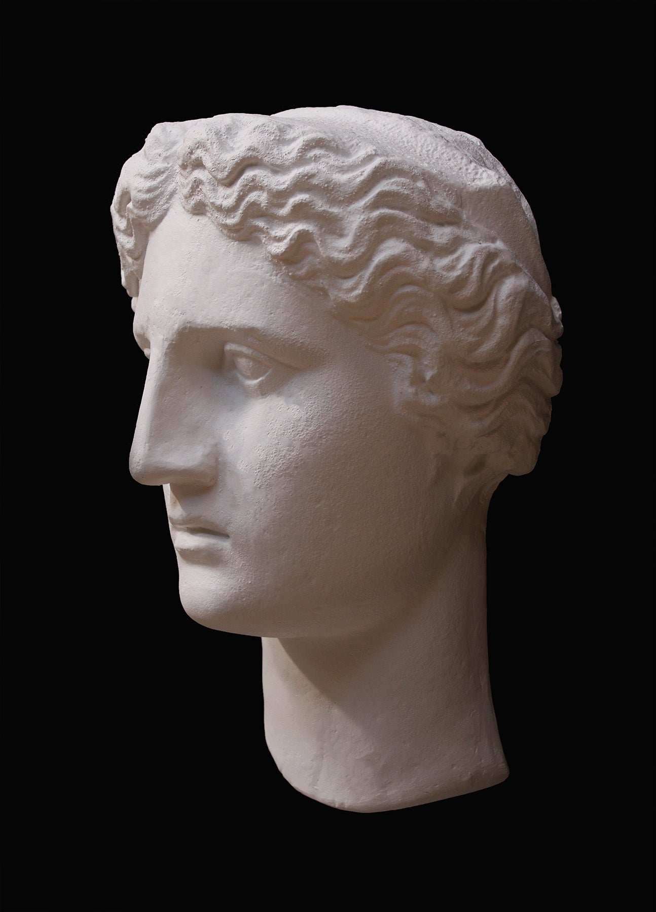 image of plaster cast sculpture mask of female, namely Athena, on a gray background
