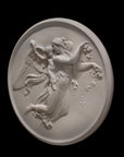 photo of plaster cast relief of female with wings flying and a cherub on her back on black background