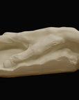 Photo of a white plaster cast of an elderly hand on a black background