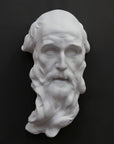 photo of plaster cast of the male face of Saint Andrew with long beard on gray background