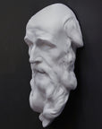 photo of plaster cast of the male face of Saint Andrew with long beard on gray background