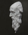 photo of plaster cast of the male face of Saint Andrew with long beard on gray background