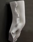 Plaster cast of a female hand on a black background