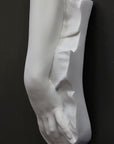 Plaster cast of a female hand on a black background