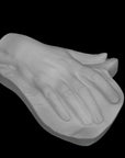 Photo of a plaster hand on a black background