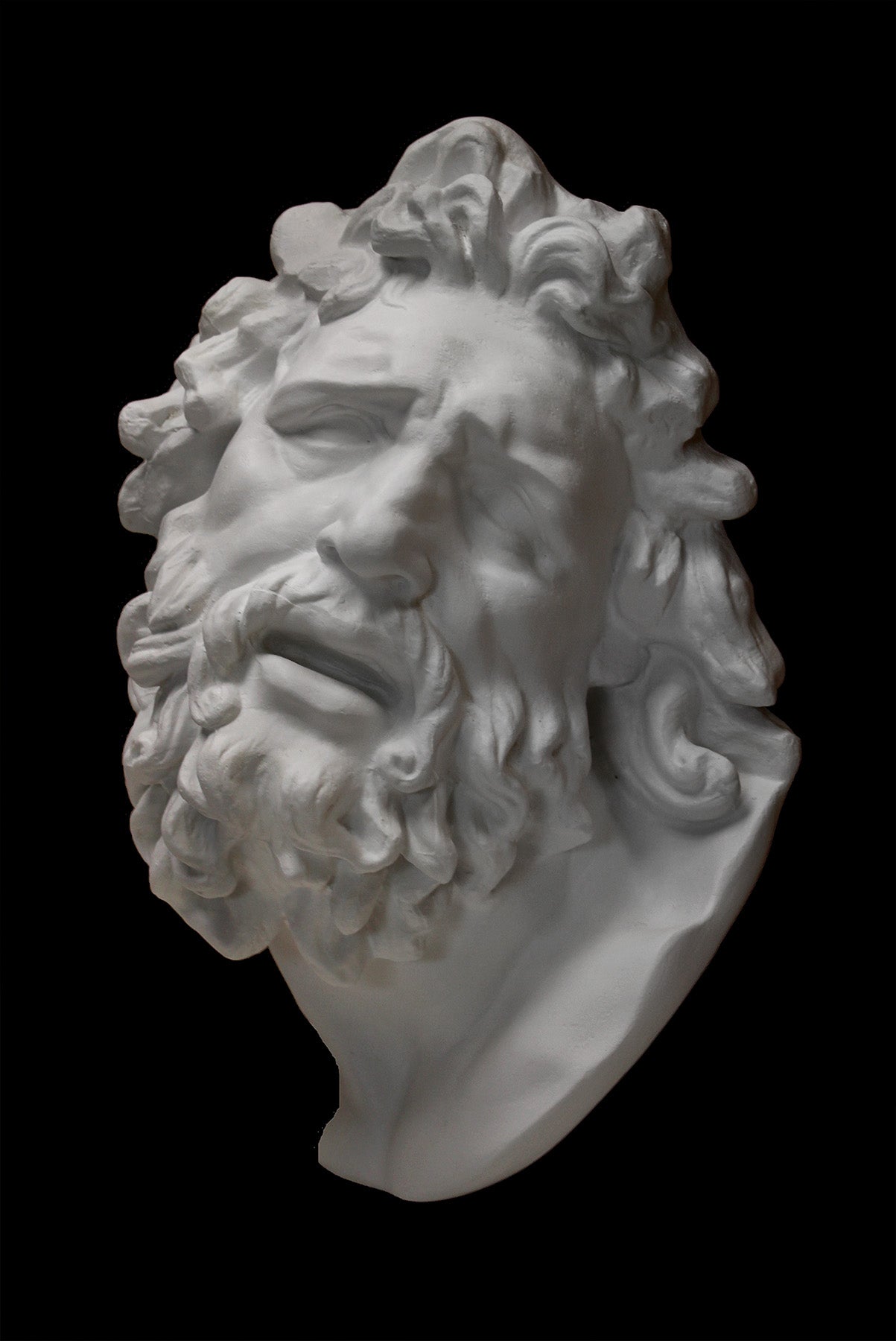 Photo of a plaster cast of the Laocoon mask on a black background