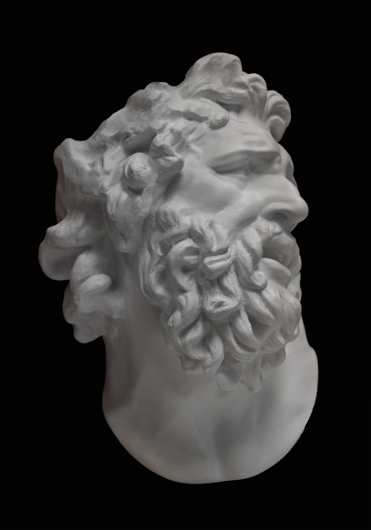 Photo of a plaster cast of the Laocoon mask on a black background