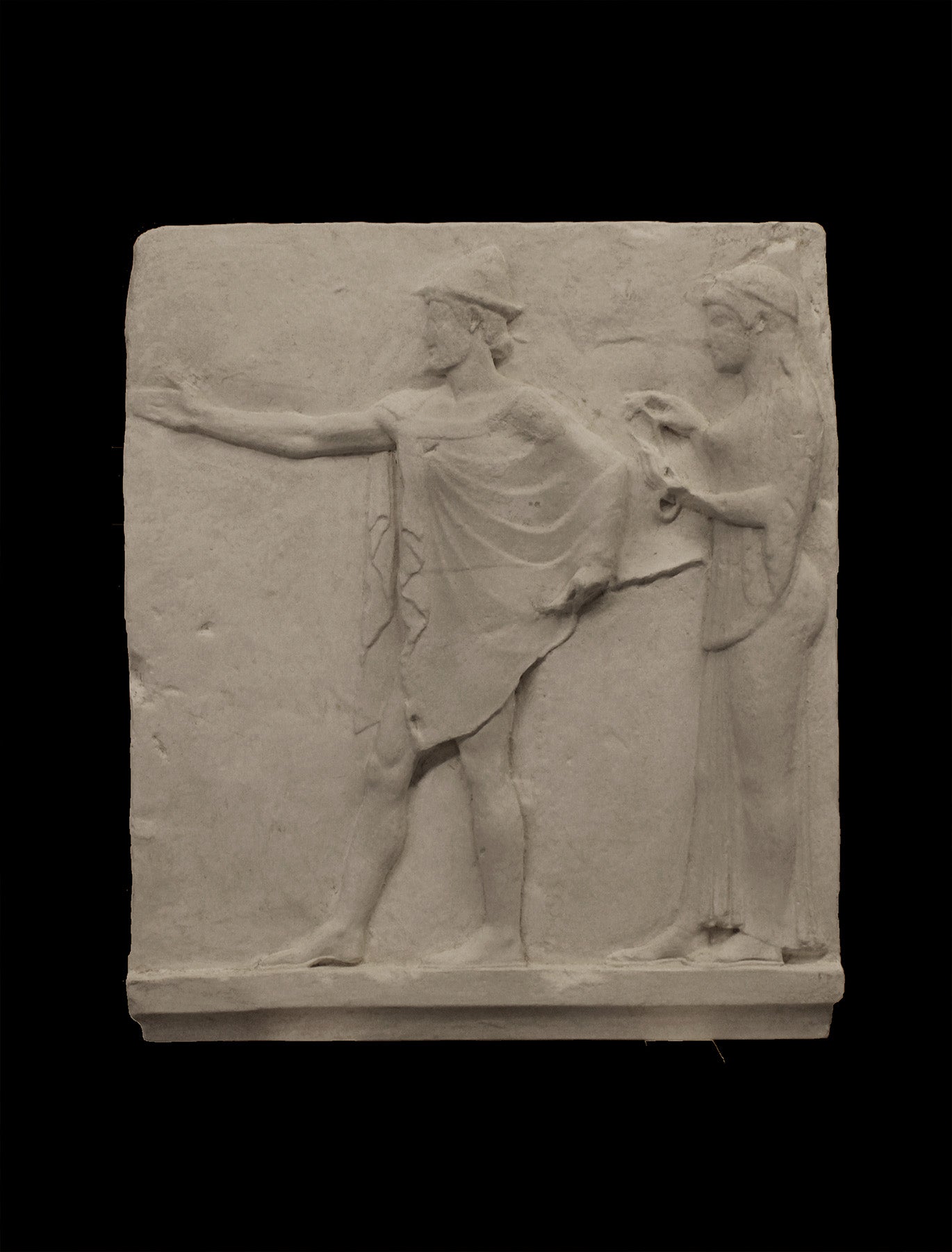 photo of plaster cast sculpture relief of two figures walking to the left, the male reaching out his right hand and the female behind him