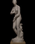 photo of plaster cast sculpture of Venus standing nude with two putti riding a dolphin at her feet on black background