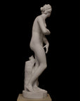 photo of plaster cast sculpture of Venus standing nude with two putti riding a dolphin at her feet on black background