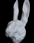 image of a plaster statue of a bust of a rabbit on a black background
