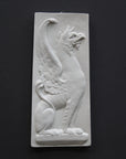 image of a plaster statue of a bust of griffin on a gray background