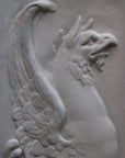 detailed image of a plaster statue of a bust of griffin on a gray background