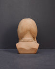 image of the back of a terracotta-colored plaster bust of the well-known Native American Massasoit on a gray background