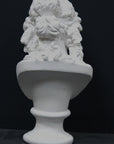 photo of plaster cast of sculpture bust of Ariadne or Bacchus with long, curly hair and head band on a black background