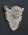 Photo of a sculpture of a angel on a gray background