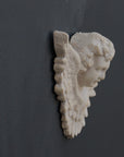 Photo of a sculpture of a angel on a gray background