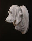 photo of a sculpture of a dog head on a black background