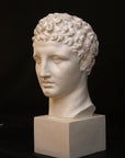 Photo of a sculpture of Hermes head on a black background