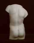 Photo of a decorative sculpture of a torso on a black background