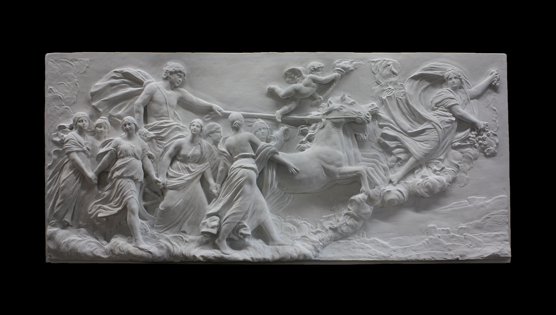 photo of a plaster cast sculpture relief of a woman, namely the goddess Aurora, flying and leading a chariot with a man pulled by horses towards the right while a cherub and other women fill the scene, on a black background