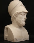 Photo of a sculpture of a man with a beard and a helmet, on a black background
