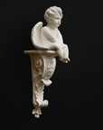 image of a plaster renaissance bracket with plaster sculpture of angel on a black background
