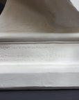 detail image of base inscriptions on a plaster sculpture bust of man, namely Abraham Lincoln, on a gray background