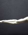 photo of plaster cast sculpture of flayed male figure study with right arm outstretched and left arm down on a gray background