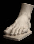 photo of a sculpture of a foot on a black background