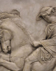 detail photo of off-white plaster cast relief sculpture of two men on horseback from Parthenon