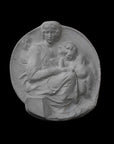 image of a round plaster relief sculpture of the Madonna and Child on a black background