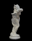 image of a plaster statue of a dancer with flowing drapery on a black background