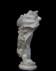 image of a plaster statue of a dancer with flowing drapery on a black background
