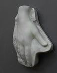 Photo of a plaster hand on a gray background