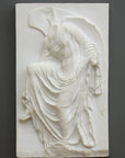 photo of cast of sculpture relief of robed figure, head now missing, reaching for her sandal on a dark gray background