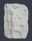 photo of white plaster cast relief sculpture of satyr with animal skin over his arm and staff in one hand walking beside a panther against gray background