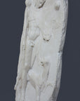 side photo of white plaster cast relief sculpture of satyr with animal skin over his arm and staff in one hand walking beside a panther against gray background