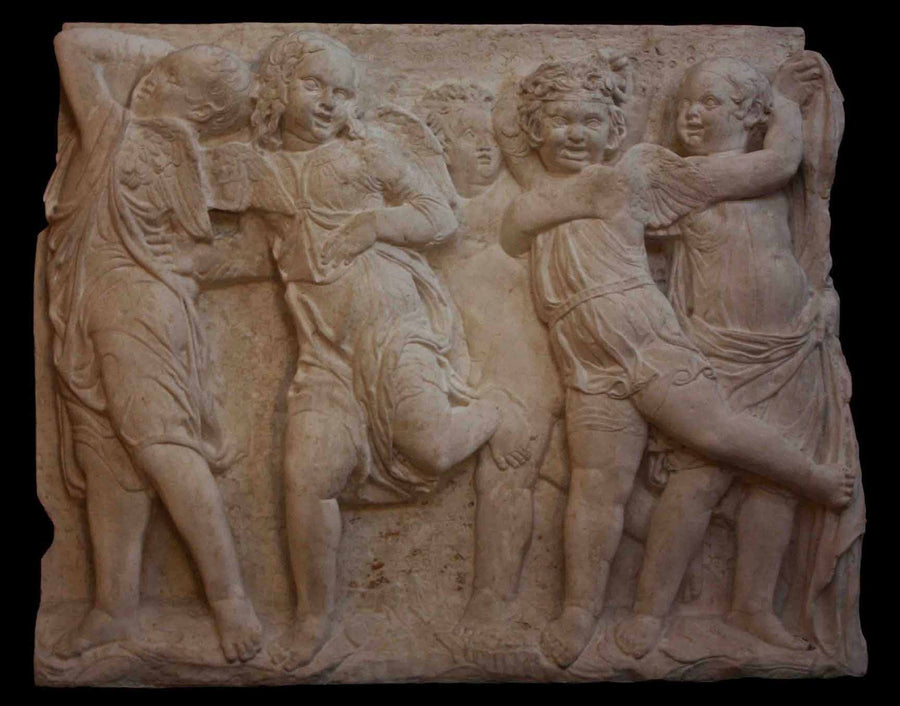 photo of plaster cast relief of children dancing with black background