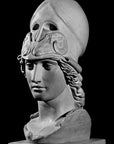 photo of plaster cast sculpture bust of female head, namely the goddess Athena, with a helmet on a black background