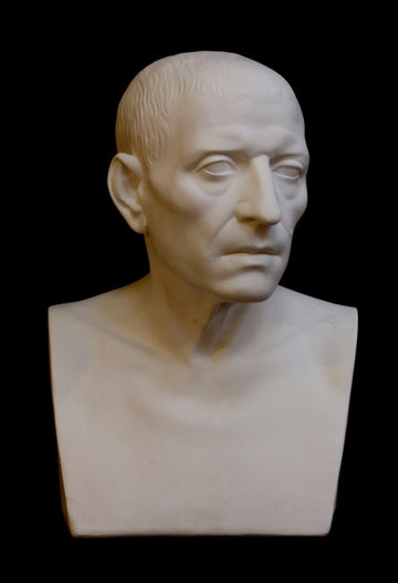 photo with black background of plaster cast sculpture of male head of Cicero with squared bust