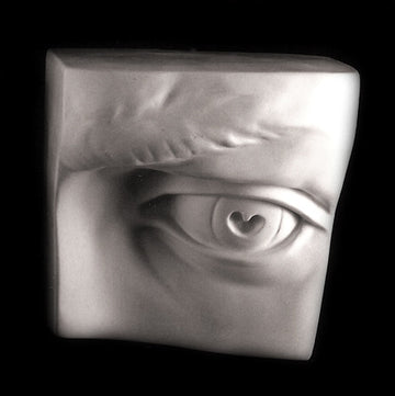 Photo of plaster cast sculpture of left eye on panel from Michelangelo's David statue on a black background