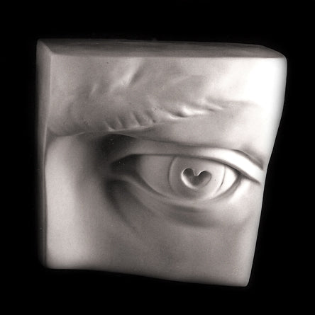 Photo of plaster cast sculpture of left eye from Michelangelo's David statue on a black background