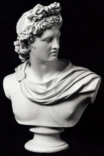 photo of plaster cast sculpture bust of man, namely the god Apollo, with hair piled high in the front and a broach near his neck holding robes on a black background