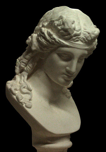photo of plaster cast of sculpture bust of Ariadne or Bacchus with long, curly hair and head band on a black background